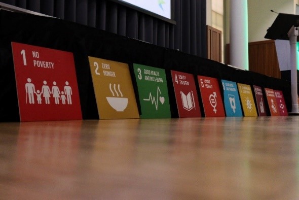 Photo of panels showing the UN's Sustainable Development Goals propped up against a stage.